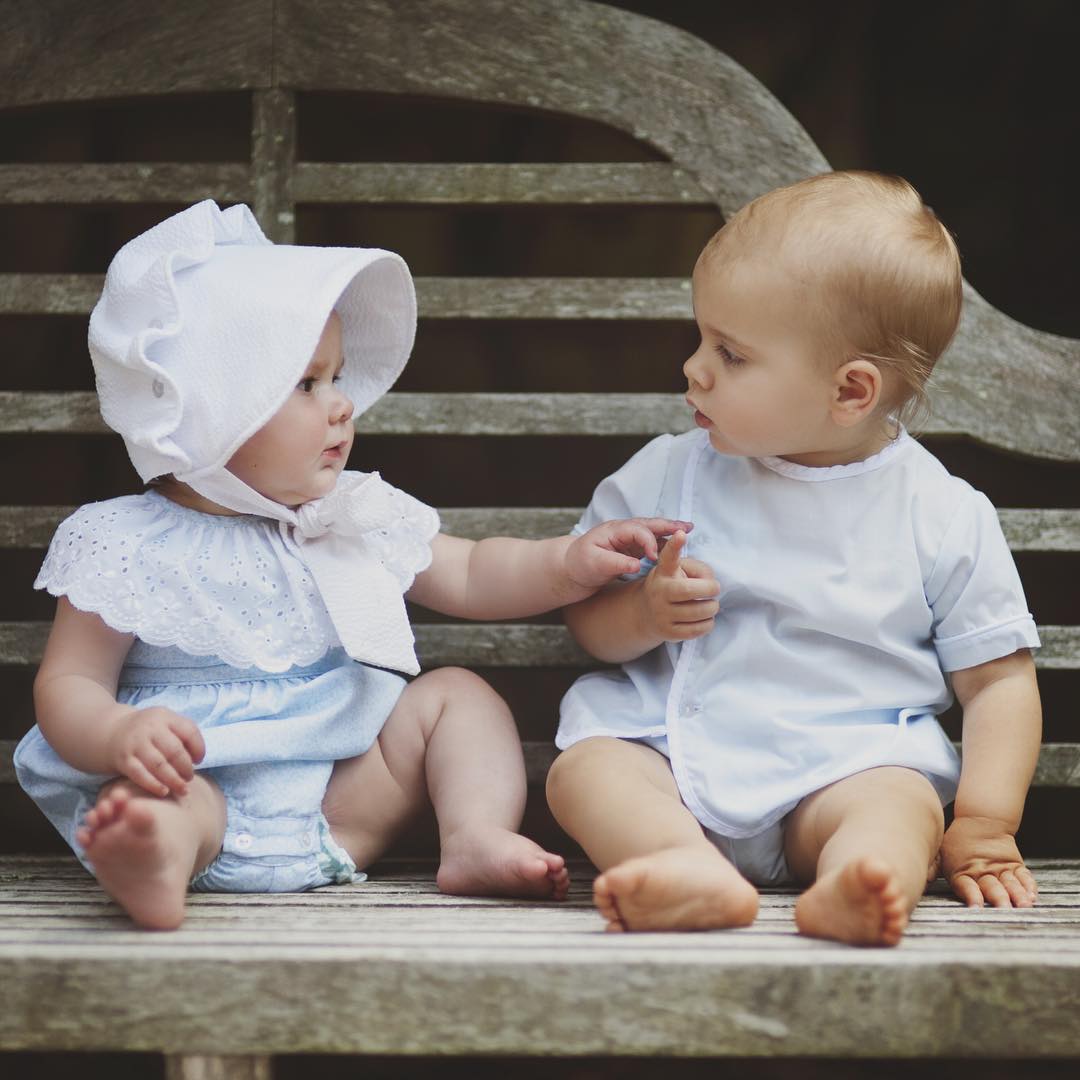 Two Babies Wearing a Bonnet